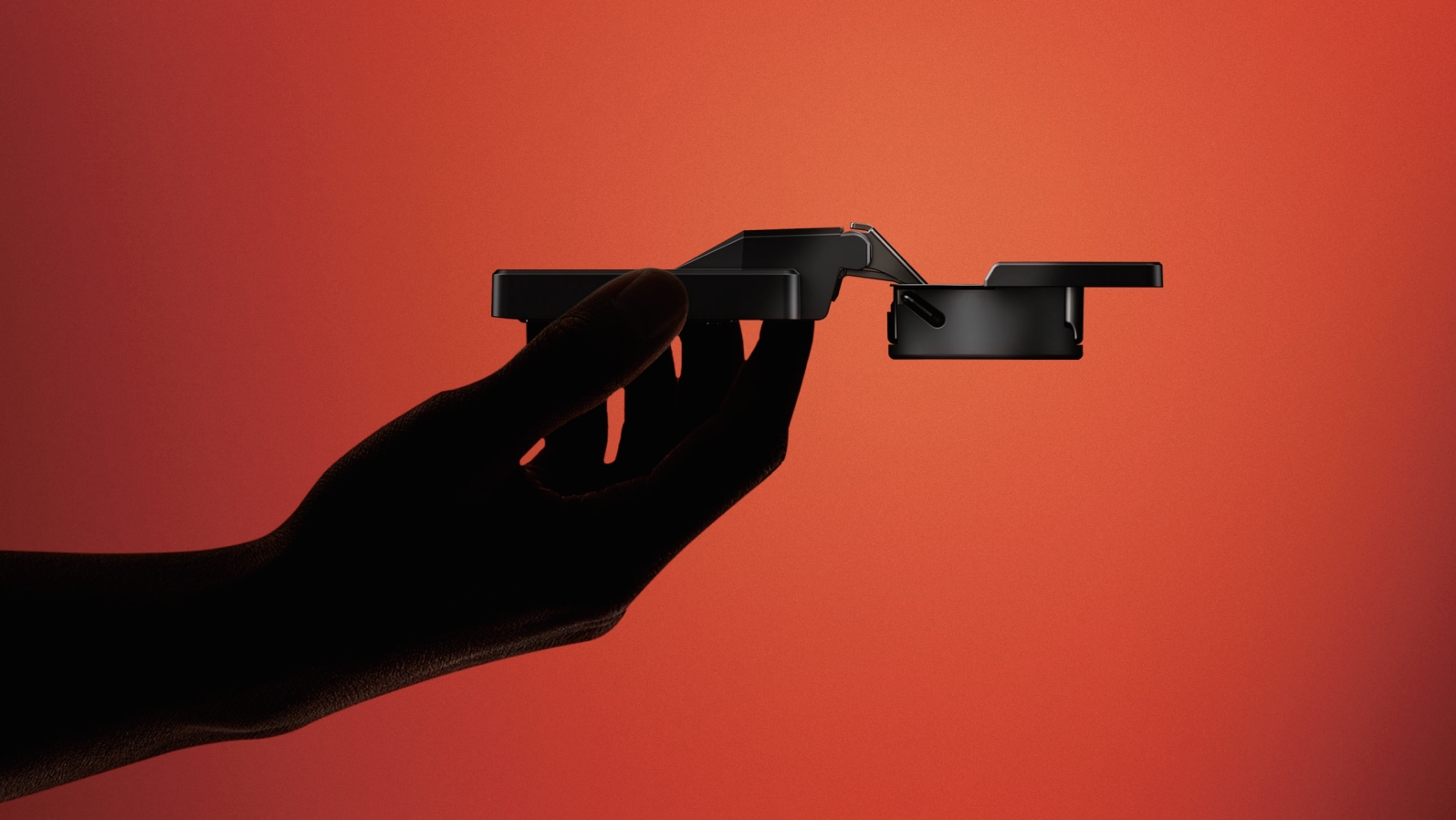 FELINE soft-closing hinge held against a red backdrop