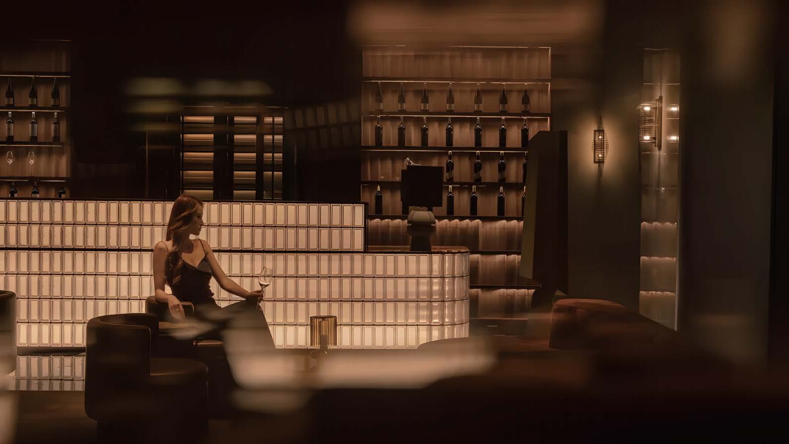 Backlit display wall with bottle storage in the living space